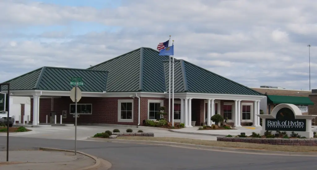 Bank of Hydro branch in Weatherford, Oklahoma: brick walls, green standing-seam roof and a white columned portico
