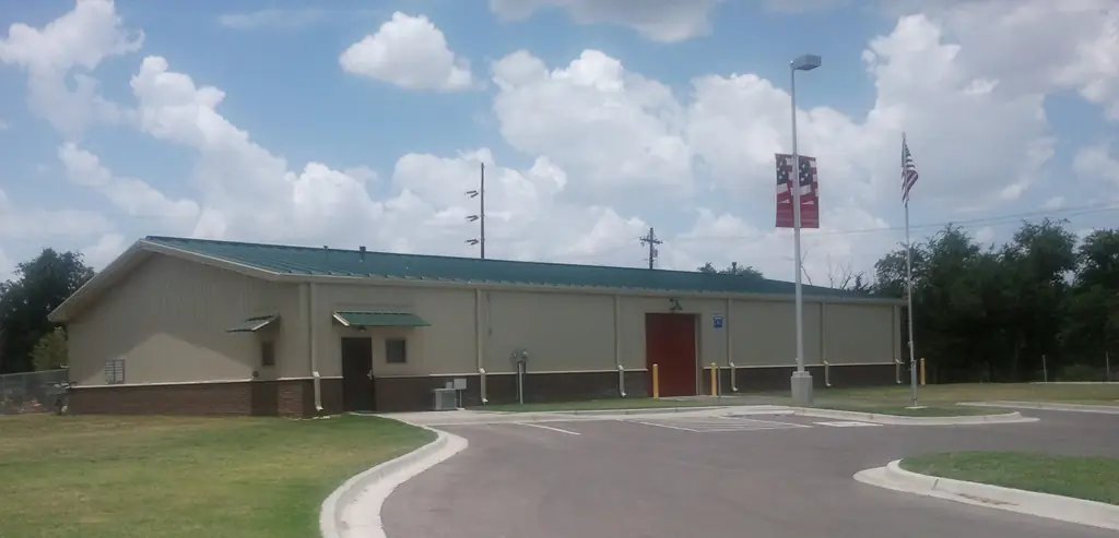Crystal Beach Park building in Woodward, Oklahoma, tan metal with a burgundy brick base