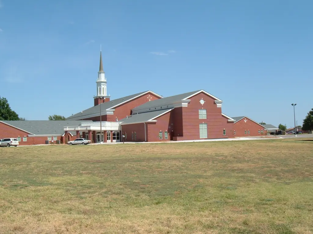 First United Methodist Church in Cheyenne, Oklahoma, red brick with a tall white steeple and arched window