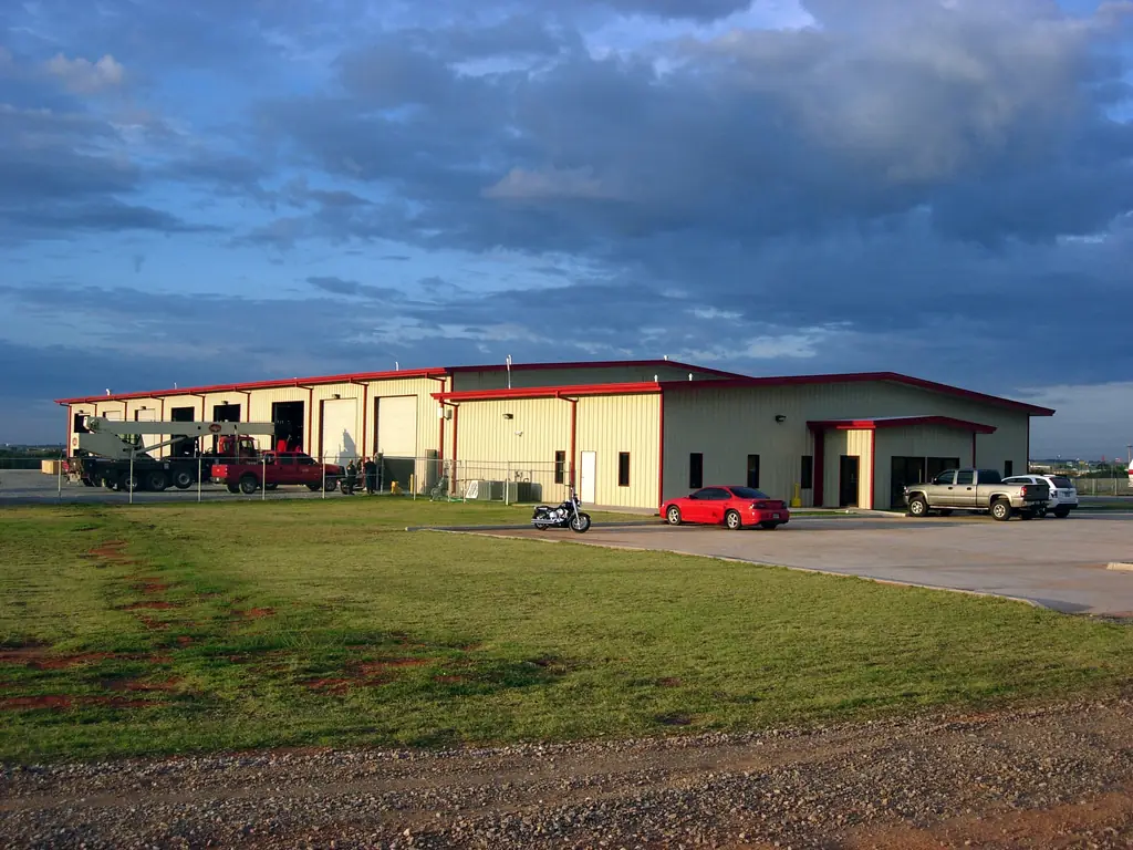Warrior Energy shop and warehouse in Elk City, Oklahoma, with red trim and service bay doors